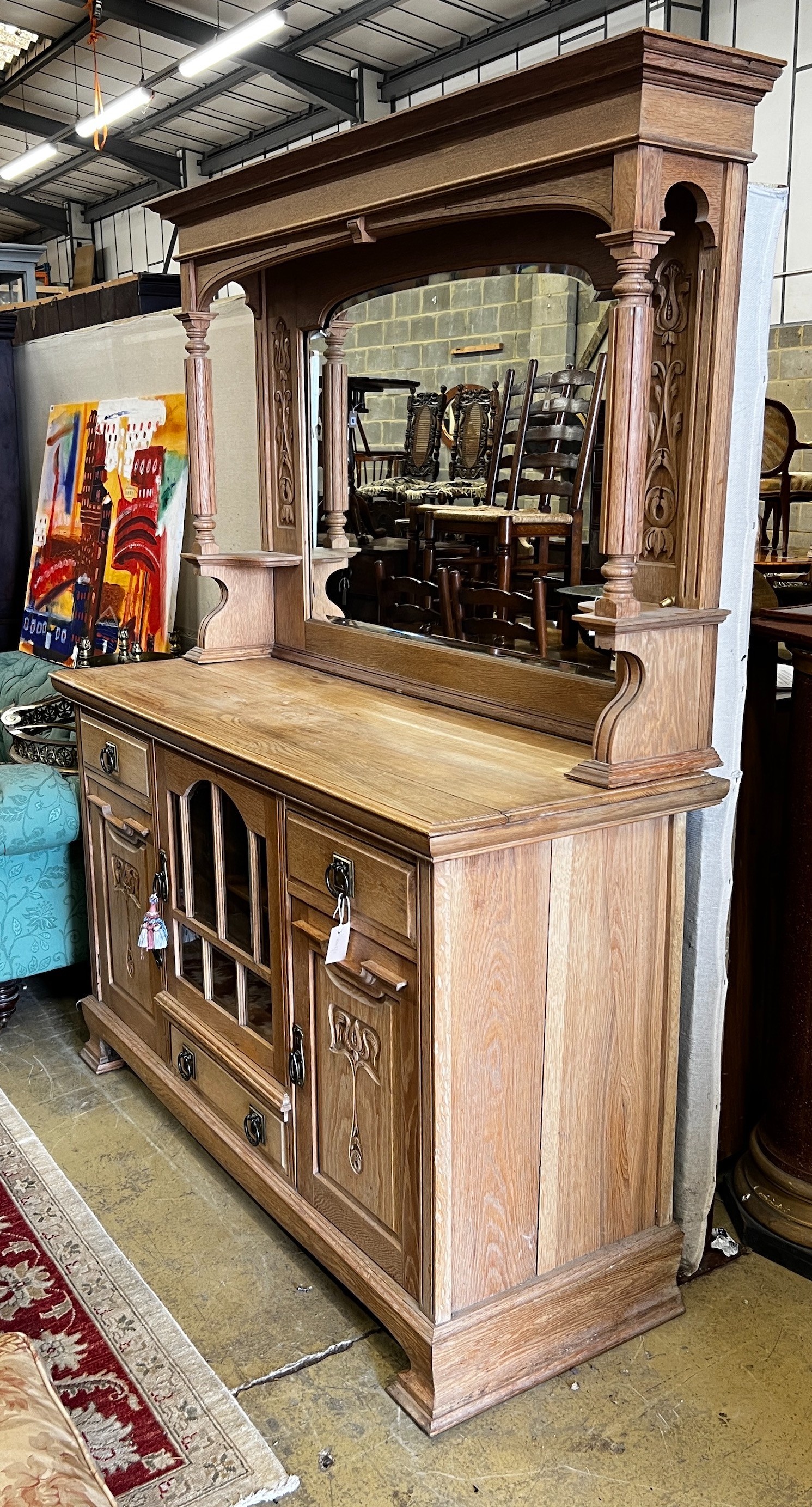 A late Victorian Art Nouveau bleached oak mirrored back sideboard, length 152cm, depth 58cm, height 195cm